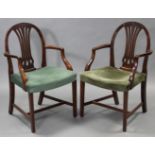 A pair of Hepplewhite style mahogany elbow chairs, the pierced splat backs with foliate-carved top
