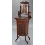 A late Victorian/early Edwardian narrow cabinet with swing mirror to the top & a quarter-round shelf