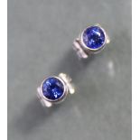 A pair of 18ct. white gold ear studs, each set single round-cut sapphire.