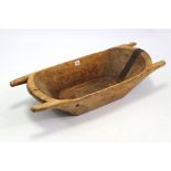 A treen rectangular dough trough, 32” long; together with a large black & white print after Luke