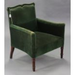 A Victorian armchair with shaped square back, curved arms, & sprung seat upholstered green velour,