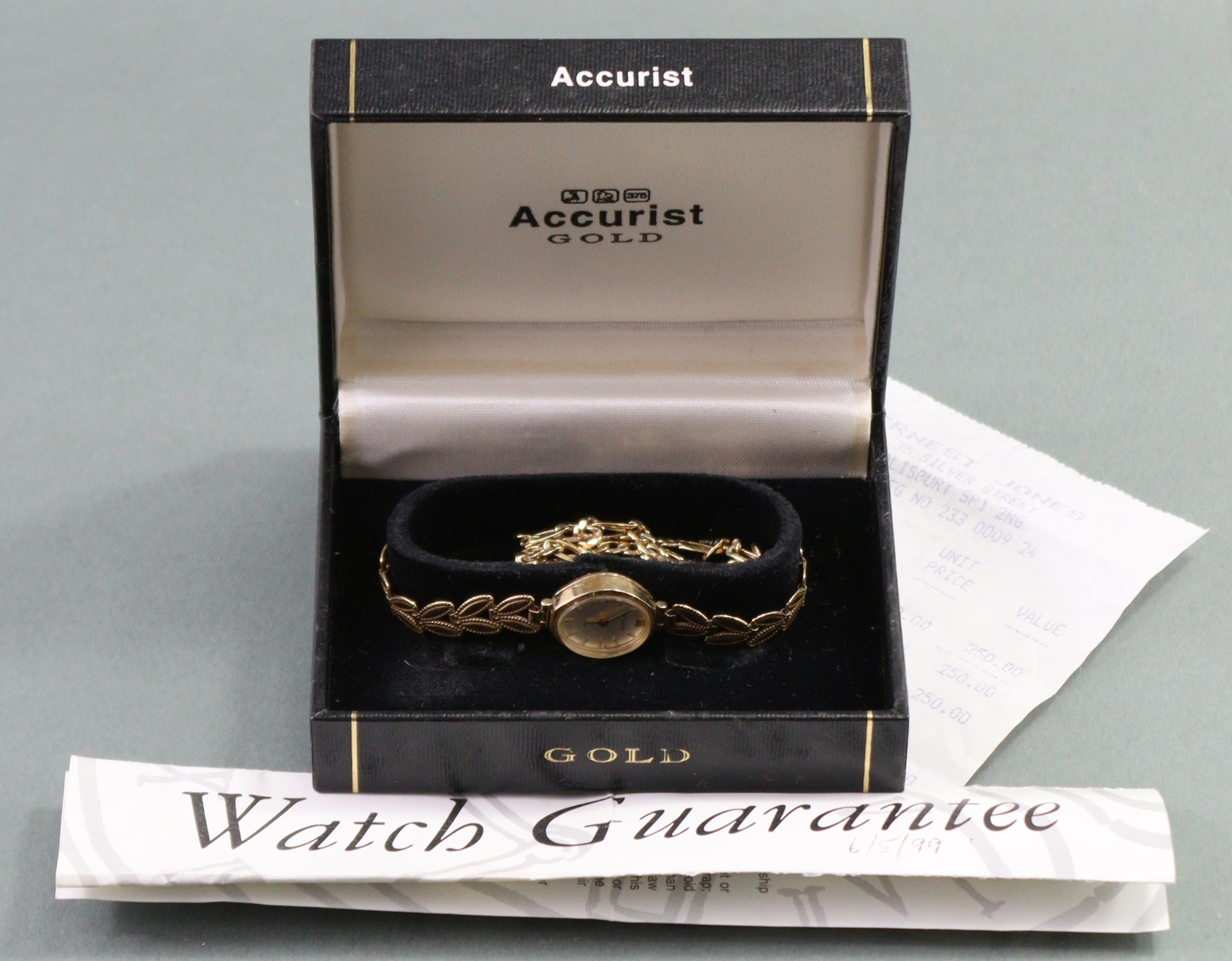An Accurist 9ct. gold ladies’ wristwatch, the oval silvered dial with gold baton numerals & roman - Image 6 of 6