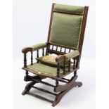 A late 19th century beech-frame American rocking chair with sprung mechanism.