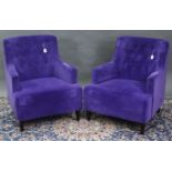 A pair of easy chairs with buttoned backs & sprung seats upholstered purple velour, & on short