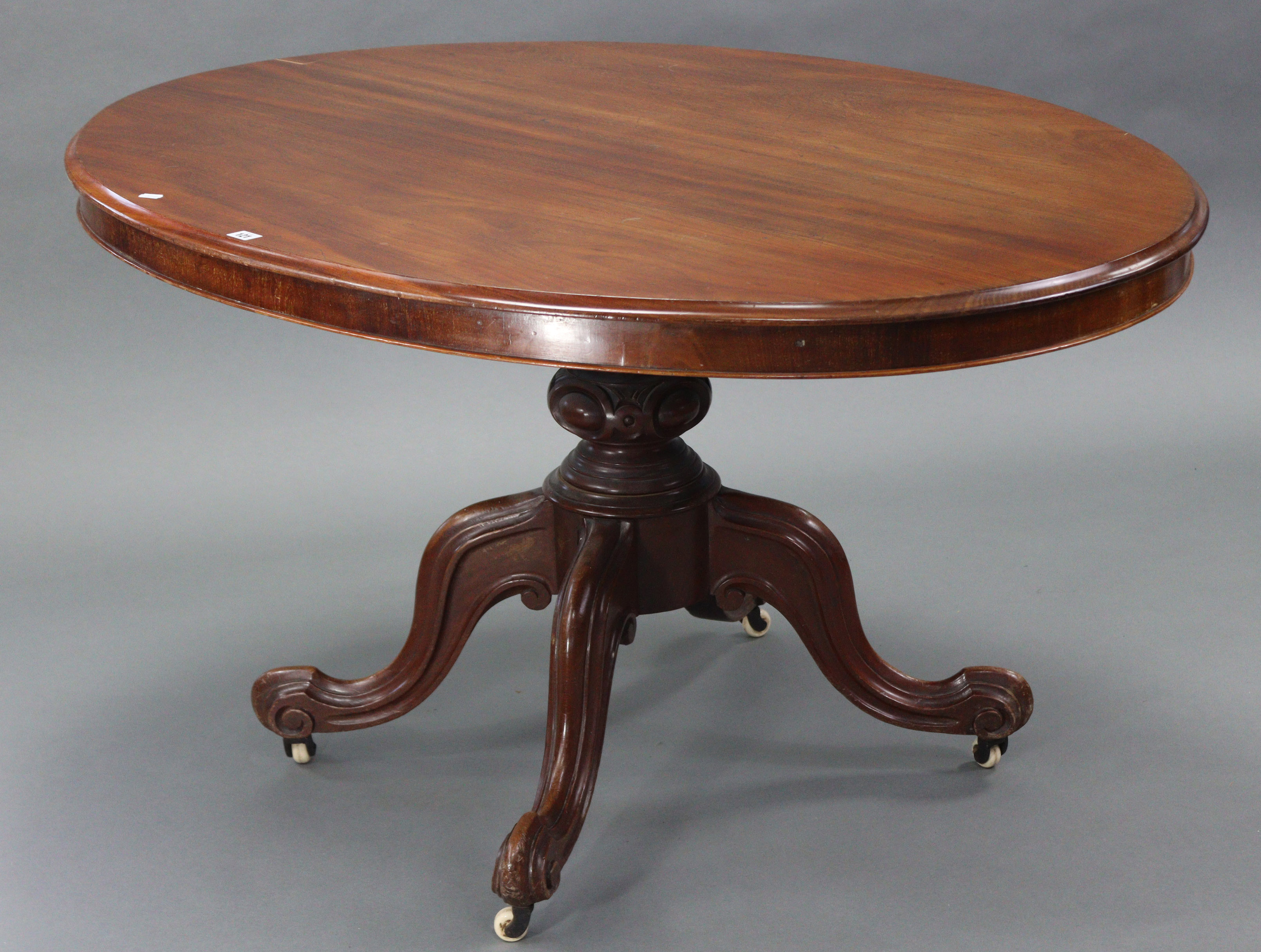 A mid-Victorian mahogany tilt-top oval centre table, with moulded edge, on bulbous carved centre