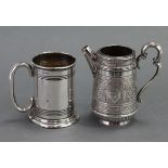 A Victorian silver cream jug of round tapered form, with looped scroll handle, round tapered