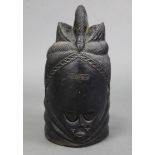 An African tribal ebonised & carved soft wood head ornament, 16½” high.
