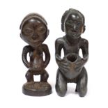 A Luba carved wood standing female figure, 9”; & a similar kneeling figure holding a bowl, 9¾”.