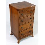 A reproduction yew wood & crossbanded small upright chest, fitted brushing slide above four long