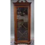 A 19th century mahogany standing corner cabinet, with broken-arch swan-neck cornice above