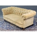 A VICTORIAN CHESTERFIELD SETTEE upholstered buttoned cream velour, with scroll arms, sprung seat, &
