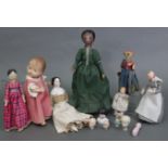 A Victorian painted wood peg doll; a later ditto; a Victorian china head-&-shoulders doll; three ot