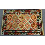 A multi-coloured vegetable dye Kelim rug, with a central repeating geometric design surrounded by