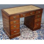 A late Victorian mahogany pedestal desk, inset gilt-tooled tan leather writing surface to the