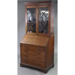 A late Victorian inlaid mahogany bureau bookcase with moulded cornice & dentil frieze, enclosed pair