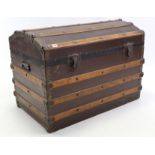 A late 19th/early 20th century ribbed domed-top travelling trunk enclosed by hinged lift-lid, & with