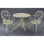 A white painted aluminium patio table with pierced circular top & on four shaped legs, 29½” diam.; &