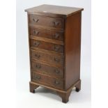 A reproduction walnut small upright chest, fitted six long drawers & on bracket feet, 17¾” wide x