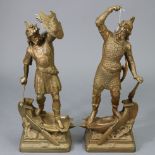 A pair of spelter gold painted tall standing male warrior figures dressed in armour, each stood upon