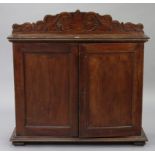 An oak hall cupboard with carved low-stage panel back, fitted two open shelves above two short