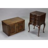 A Georgian-style mahogany bedside chest with inverted serpentine front, fitted brushing slide