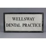 A black & white painted wooden sign “WELLSWAY DENTAL PRACTICE”, 48” wide x 24” high.