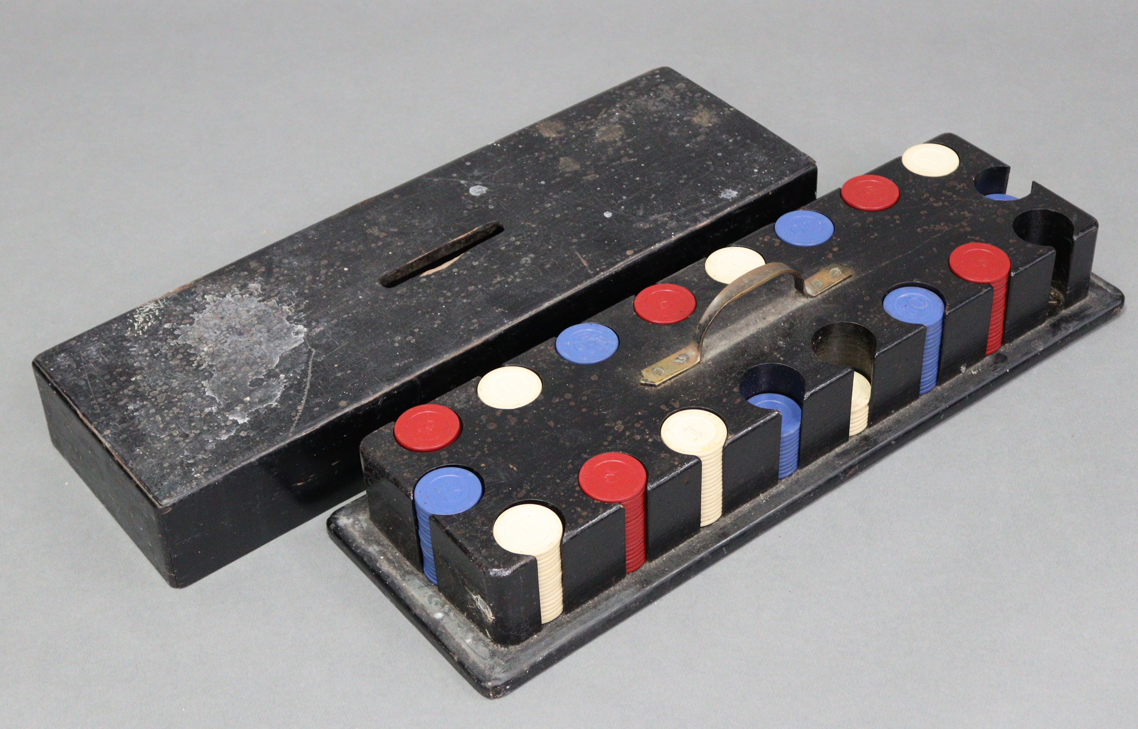 A near complete set of multi-coloured plastic gaming counters with ebonised wooden case, 19¾”