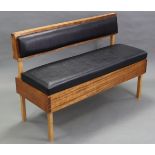 A hardwood box-seat settle, with upholstered black leather cushions set to the back & hinged seat,