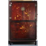 A Chinese red & black lacquered drinks cabinet, with painted decoration of swimming fish, the