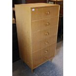 A MEREDEW light oak veneered upright chest, fitted six graduated drawers with turned knob
