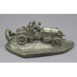 A large pewter inkwell modelled as a 1920’s style racing car with driver & co-driver on board, the