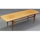 A Danish teak low rectangular coffee table on four slender tapered legs, 59½” wide x 17½” high x