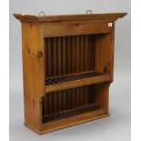A pine wall-hanging two tier plate rack with moulded cornice, 28¼” wide x 30½” high x 12½” deep,