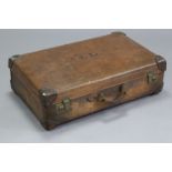 An early-mid 20th century leather-bound & fibre-covered suitcase with brass twin lever locks,