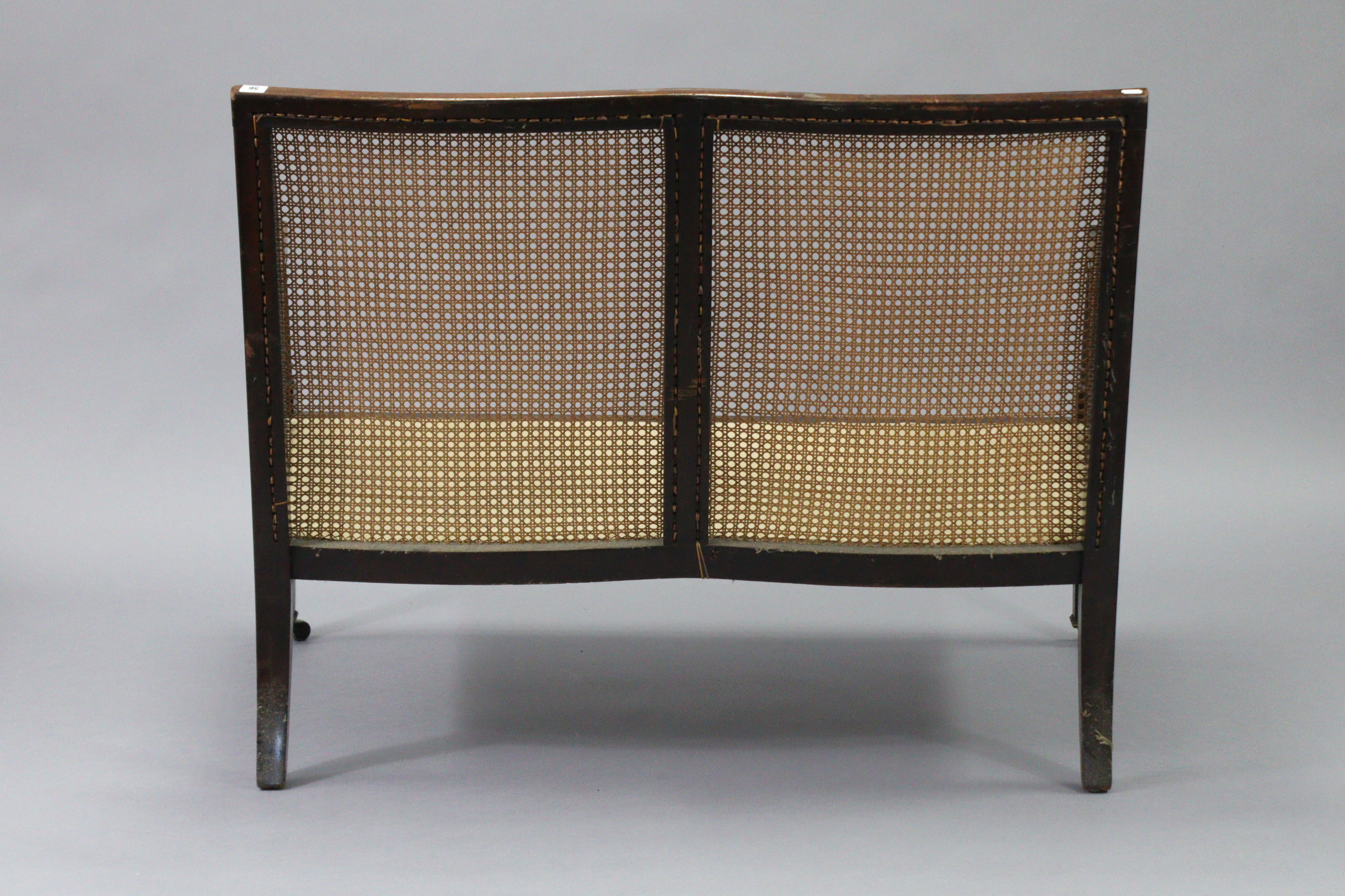 A mahogany two seater bergere settee in the late George III style, with moulded edges, turned arm - Image 5 of 8