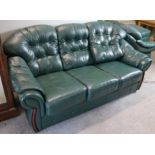A green leather four-piece lounge suite comprising a three-seater settee, 77” long, a pair of