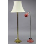 A brass standard lamp with fluted column & square platform base with four lion-paw feet, with shade,