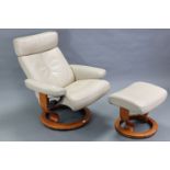 An Ekorness “Stressless” reclining swivel armchair & matching foot stool,upholstered cream leather.