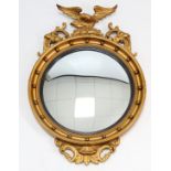 A regency-style gilt frame convex wall mirror with sphere border, & with eagle surmount, 22” diam. x