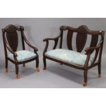 An Indonesian carved hardwood frame two-seater settee, the shaped back with foliate decoration, with