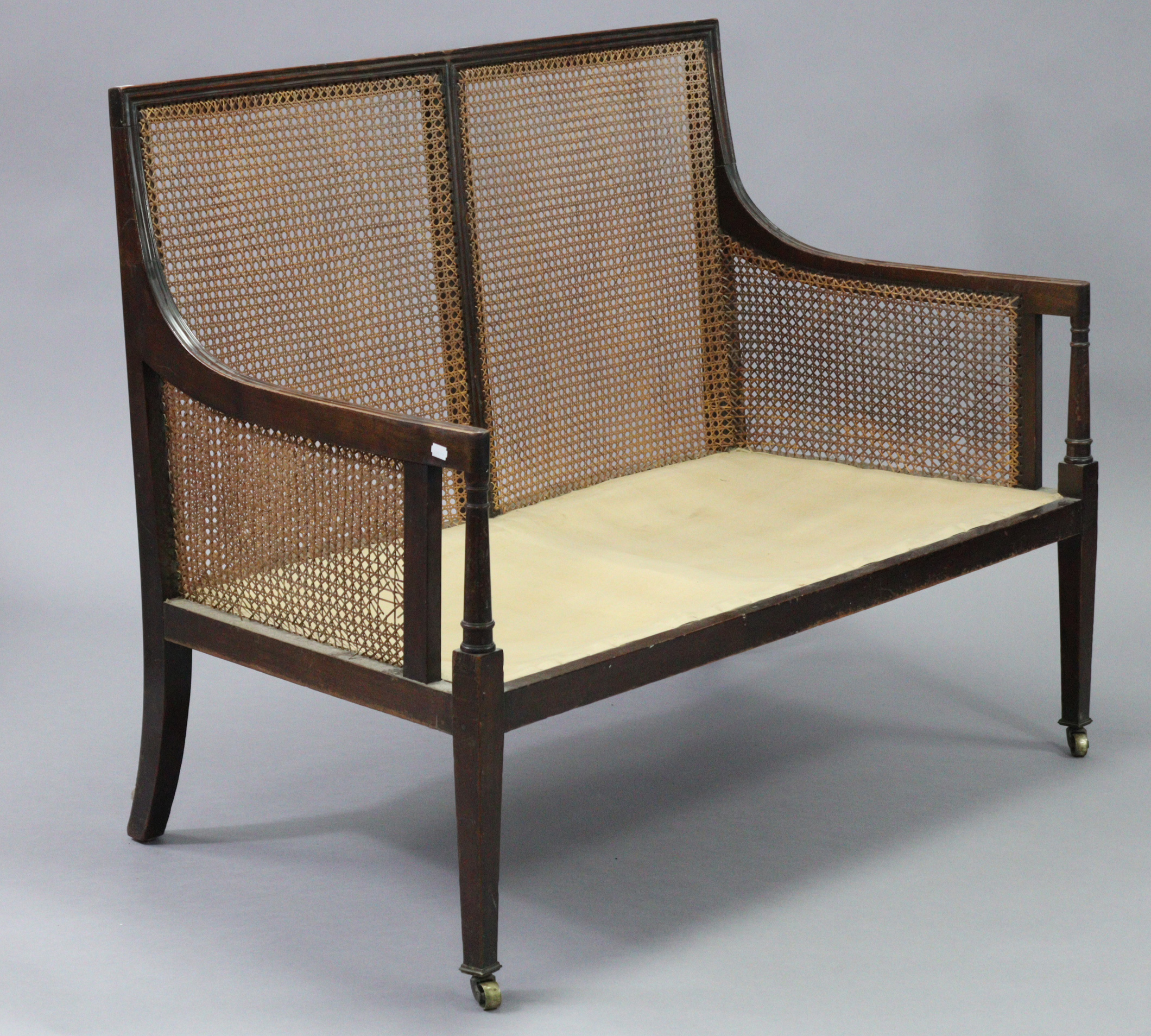 A mahogany two seater bergere settee in the late George III style, with moulded edges, turned arm - Image 4 of 8