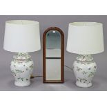 A pair of Chinese-style porcelain baluster table lamps, decorated with butterflies amongst