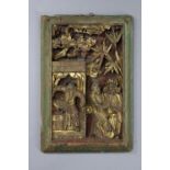 A carved giltwood panel depicting an oriental figure scene, 12½” x 8¾”.
