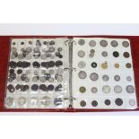 An interesting collection of mostly British coin s arranged in plastic pocket sheets in a ring-