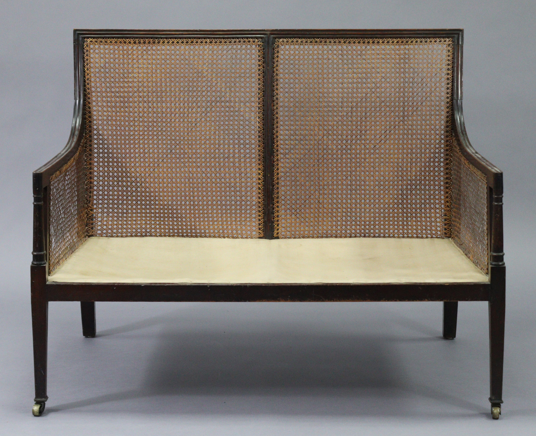 A mahogany two seater bergere settee in the late George III style, with moulded edges, turned arm - Image 3 of 8