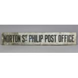 A VINTAGE WHITE & BLACK ENAMELLED RECTANGULAR SIGN “NORTON ST PHILIP POST OFFICE”, 48” x 8”.