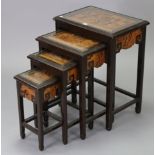 A Chinese carved hardwood & dark stained nest of four rectangular occasional tables, each with