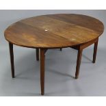 A late 19th/early 20th century mahogany oval gate-leg dining table on six square tapered legs, 48” x