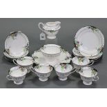 A Shelley China twenty-one piece tea service with printed decoration of peaches & grapes, on a white
