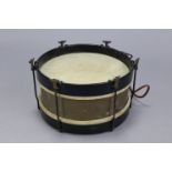 A military marching band snare drum, 9” high x 15” wide.